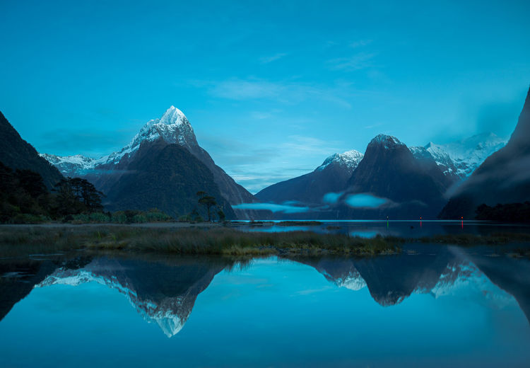 Reflection of mountain in lake against blue sky