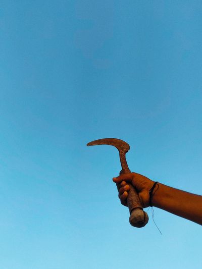 Low angle view of person hand against clear sky