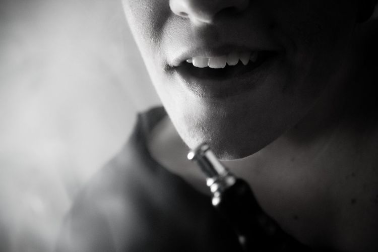 Midsection of person with hookah pipe