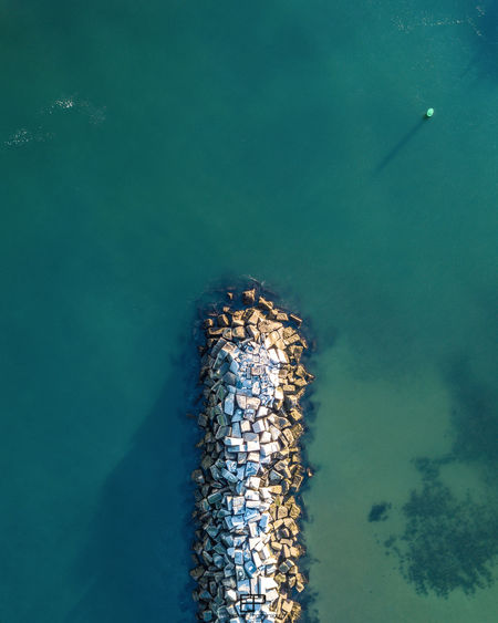 Aerial view of rock formation at sea