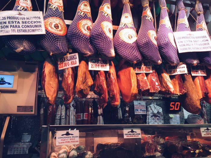 Low angle view of dried meat hanging at store for sale
