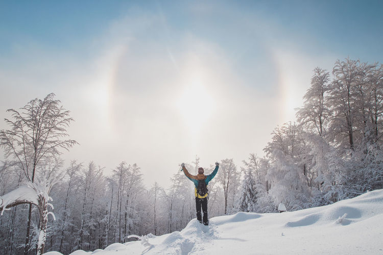 Adventurer enjoys an unusual natural phenomenon called the halo effect. winter scenery