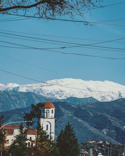 Scenic view of building and mountains against sky