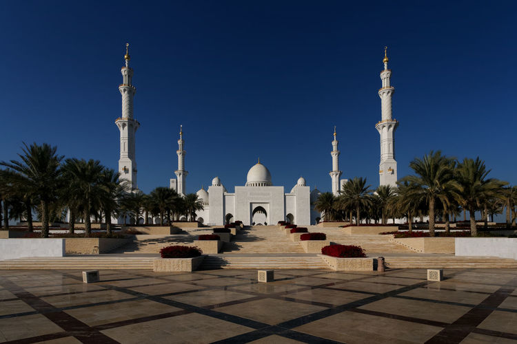 Grand mosque against clear blue sky
