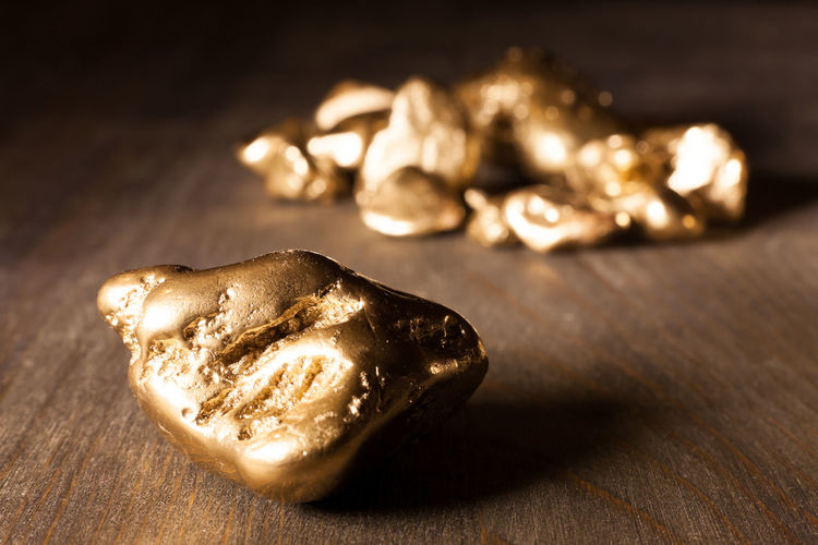 Close-up of golden nuggets on wooden table