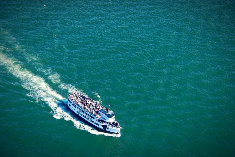 High angle view of crowd traveling on ferry over sea