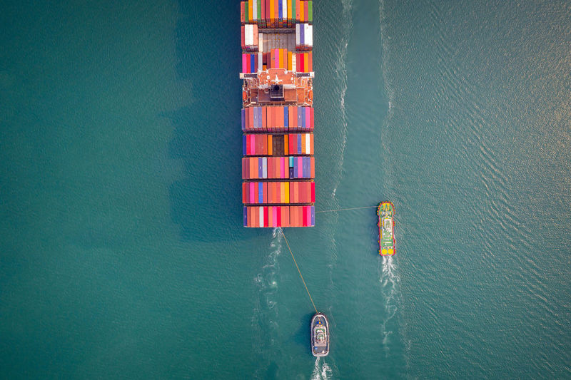 Container ship in export and import business and logistics. aerial view