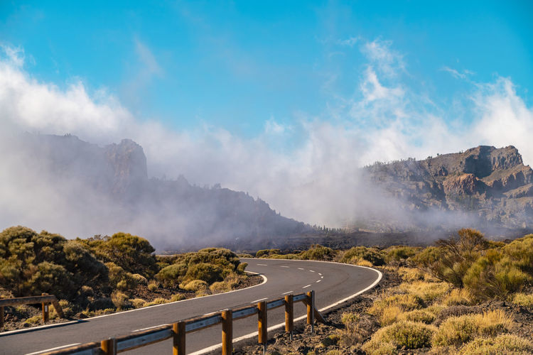 Road in teide national park on high altitude with clouds