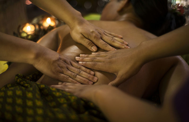 Low section of woman massaging customer