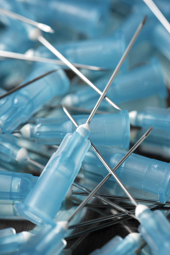 Close-up of syringe needles on table