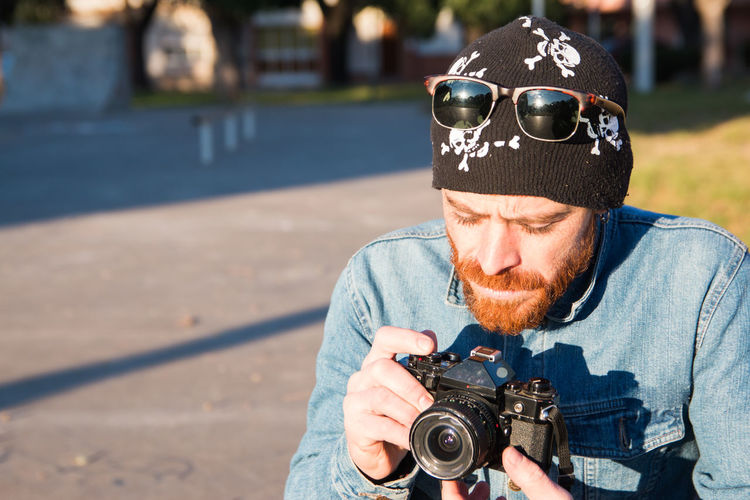 Trendy photographer and his 35mm camera