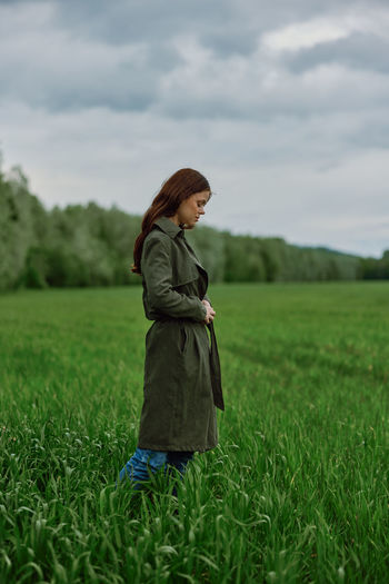 Side view of woman standing on field