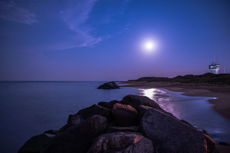 Scenic view of sea against sky under the moon by the beach