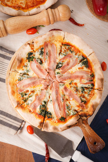 High angle view of pizza on cutting board
