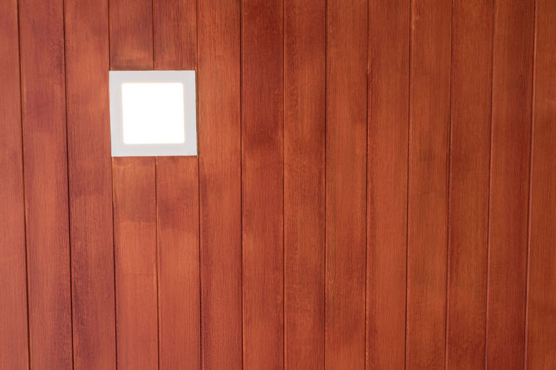 A recessed lamp in artificial wood ceiling