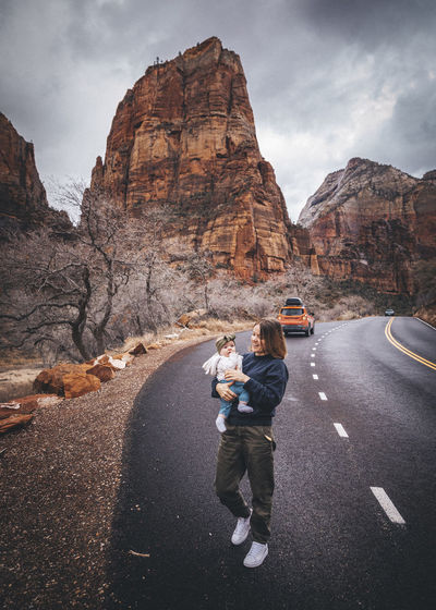 A woman with a child is walking in zion national park, utah