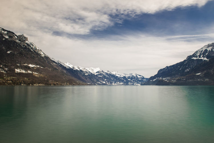 Scenic view of lake and mountains against sky