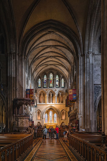 Tourists visiting and sightseeing interior of st patricks cathedral, ireland