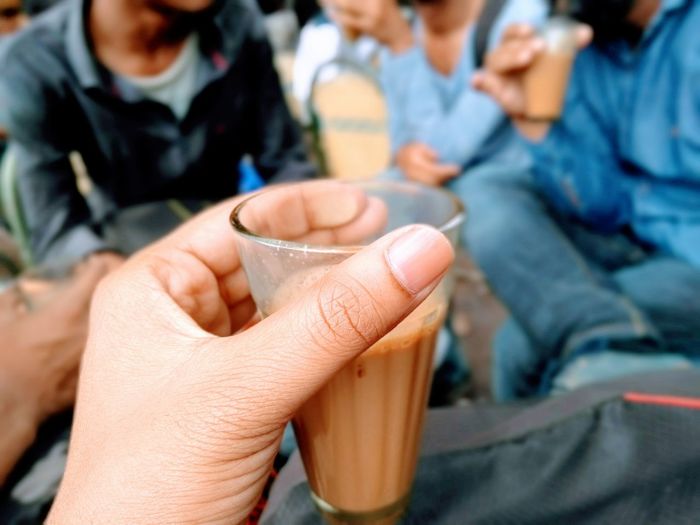 Midsection of people holding drink