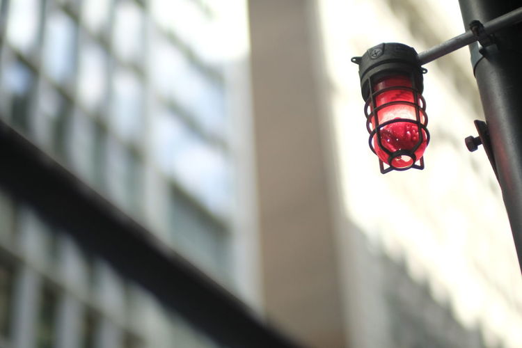 Low angle view of illuminated lantern hanging on building