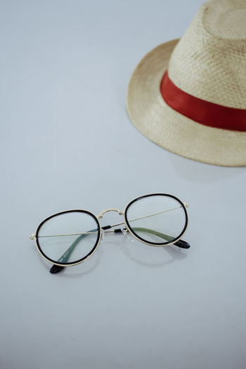 High angle view of eyeglasses on table against white background