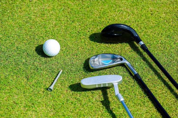 High angle view of golf ball on green grass