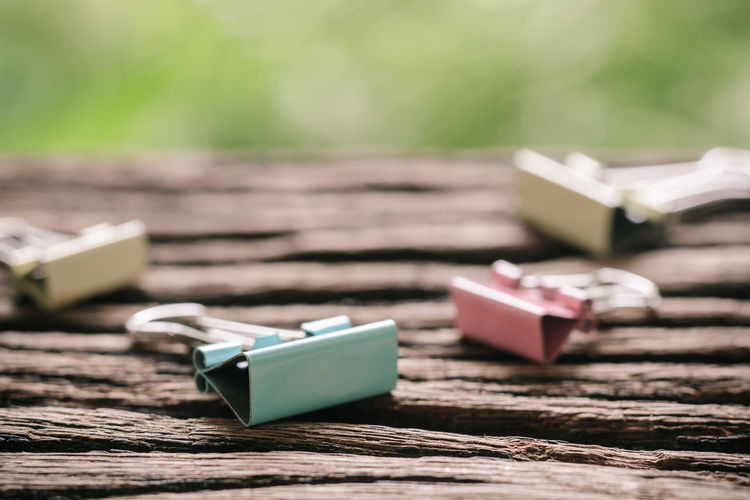 Close-up of binder clips on wooden table