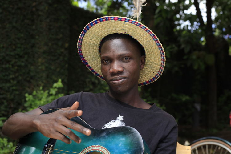 Portrait of smiling man holding hat