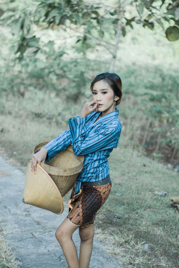 Full length of woman standing in basket