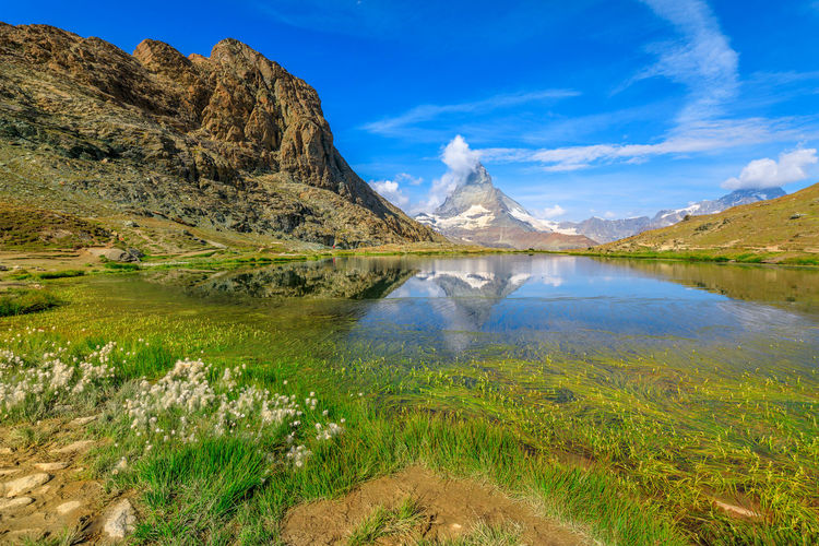 Scenic view of lake and mountains against sky