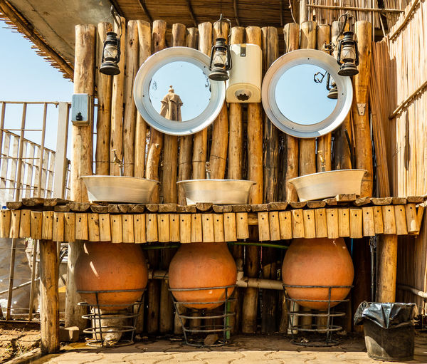 Open washroom of a good restaurant on the nile with water amphorae, metal bowls, faucets, sudan