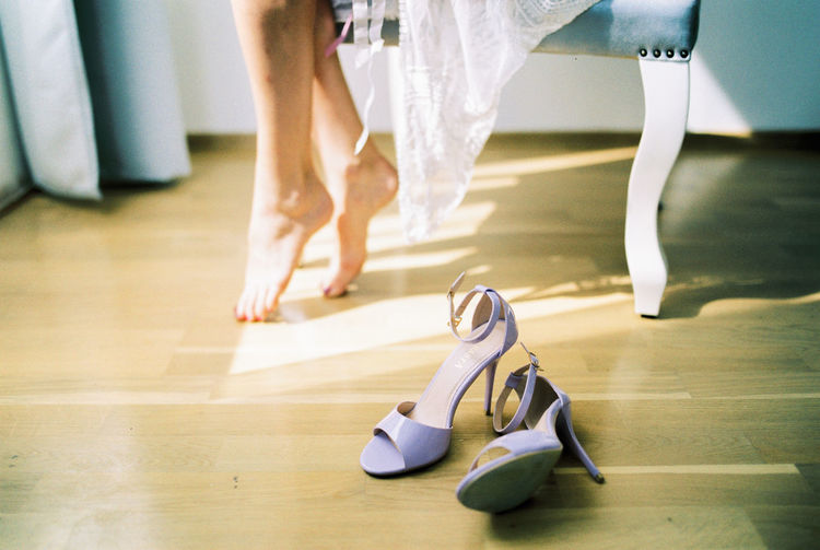 Low section of woman standing on hardwood floor