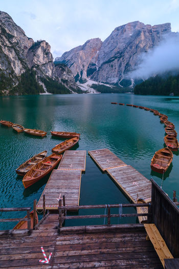 Pier on lake against mountains