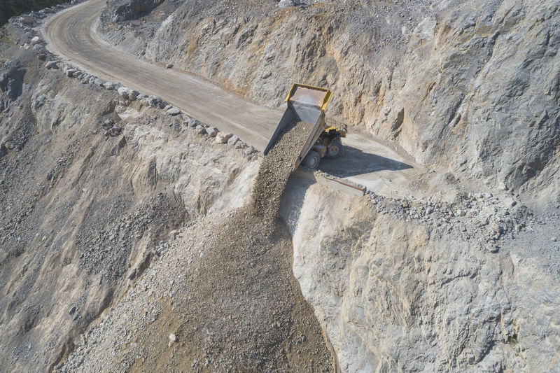 Mining dumper unloading from aerial view