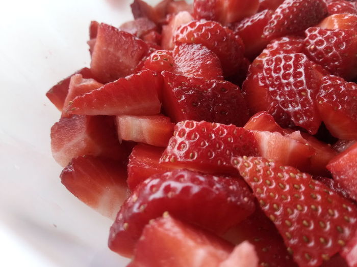 Full frame shot of chopped strawberries in plate