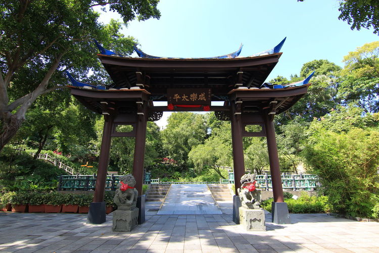 Torii gate entrance against trees