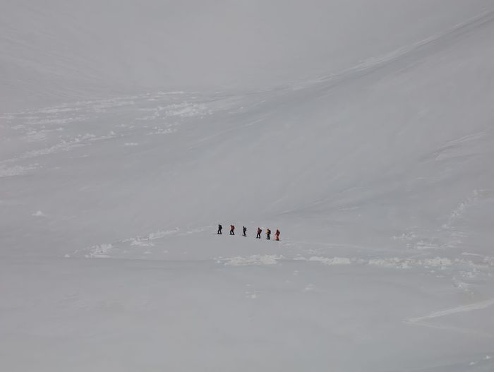 The climbers are in the snow desert, scenic view of snow covered mountain