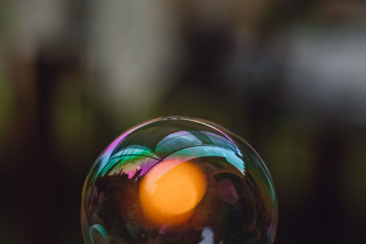 Close-up of multi colored ball in glass