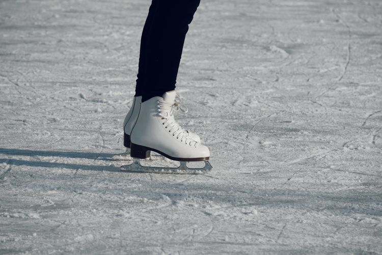 Low section of person ice skating in snow