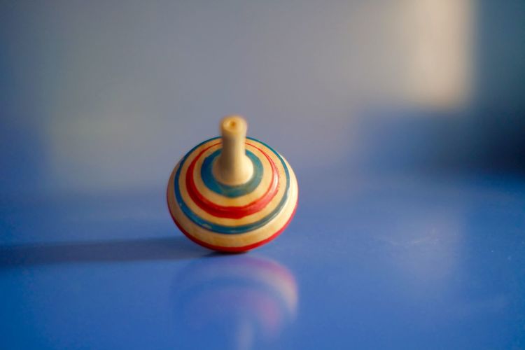 Close-up of colorful wooden spinning top on table
