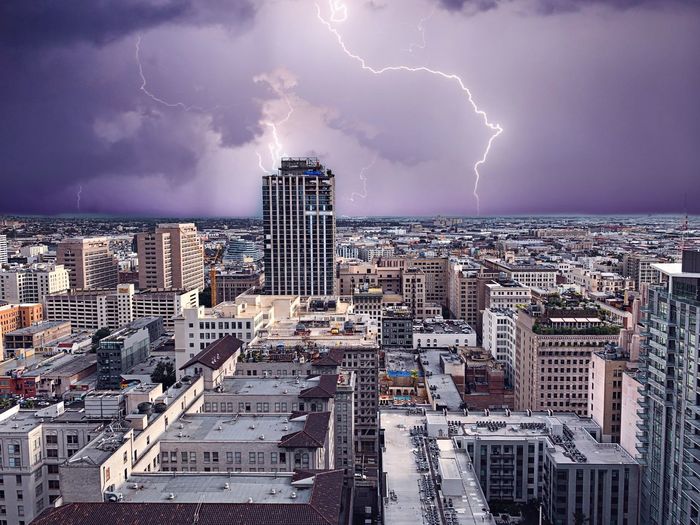 Panoramic view of lightning over buildings in city