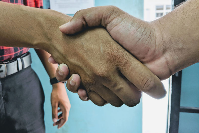 Midsection of man shaking hands 