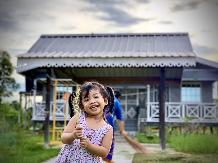 Portrait of girl against building