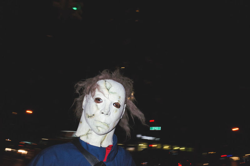 Portrait of person on illuminated mask at night