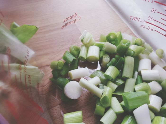 High angle view of spring onions in jar