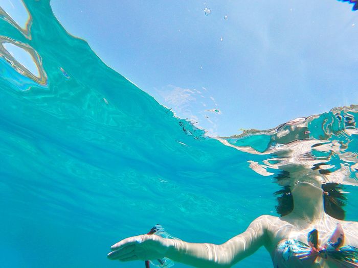 Low angle view of woman swimming underwater