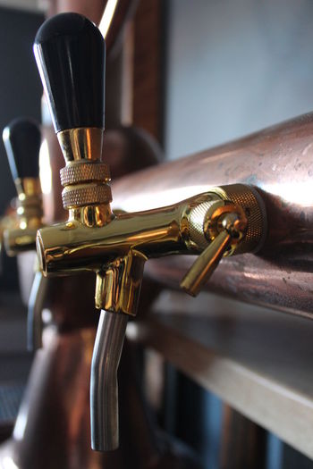 Close-up of beer taps at microbrewery
