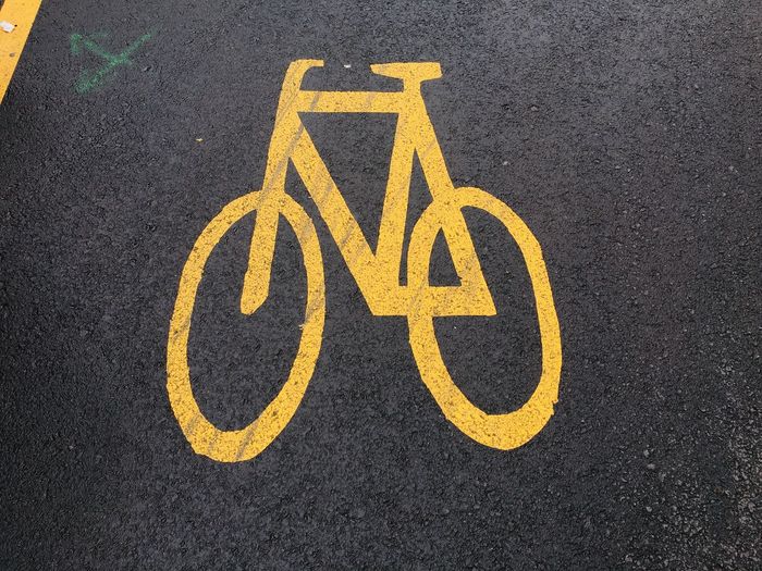 High angle view of yellow sign on road