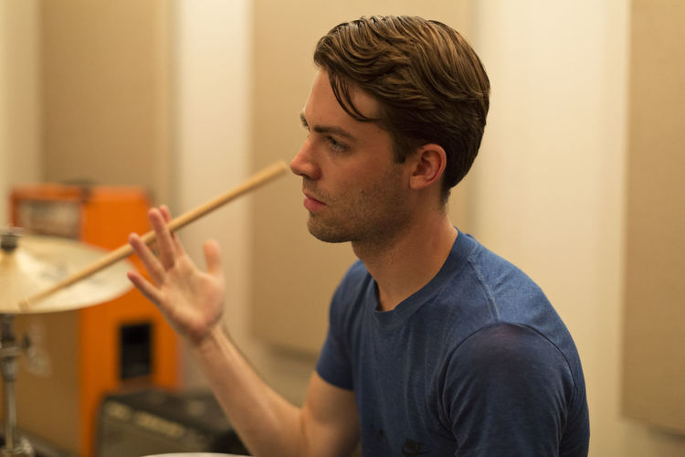 Young musician twirling a drumstick between his fingers