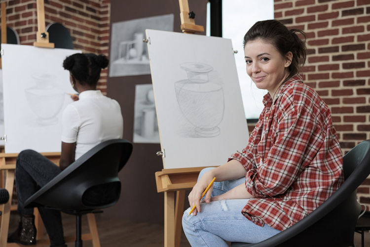 Portrait of female sketcher in workshop